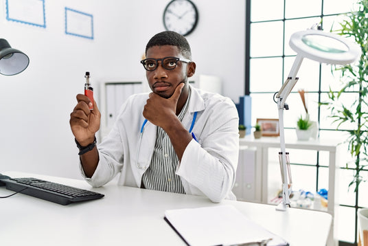 Doctor holding a vape device.