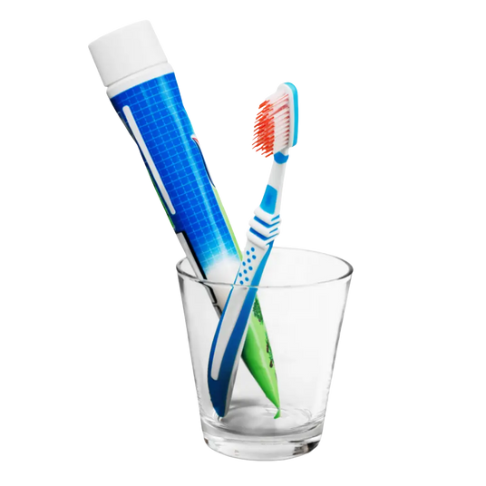 Toothpaste and a toothbrush in a glass