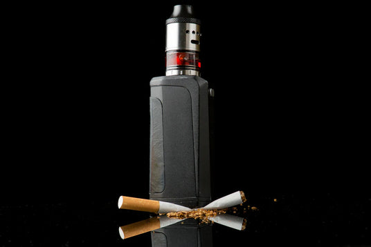 Electronic cigarette with two cigarettes on a black background