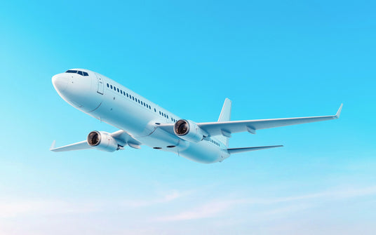 Commercial airplane flying against a clear blue sky